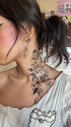 a woman with a flower tattoo on her neck