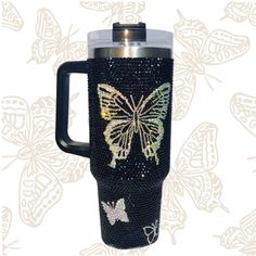 a travel mug with a butterfly design on it