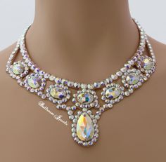 This necklace was created with Crystallized™ Swarovski Elements aurora borealis clear crystals. The necklace is 2 ¾ inches at the widest point in front and tapers in the back for comfort. There is a large pear shaped stone in the front and oval stones wrapping up the sides creating this dramatic look! This will fill in the neckline of your dress! The stones are not secured with any metal fittings so this will not snag your costume or your partners. This design will match any dress that you own b Oval Crystal Necklaces For Parties, Oval Stone Necklaces For Wedding, Necklace Shapes, Dancesport Jewelry, Ballroom Necklace, Ballroom Jewelry, Wicca Jewelry, Horizontal Bar Necklace, Sparkly Necklace