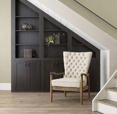 a chair sitting on top of a hard wood floor next to a book shelf filled with books