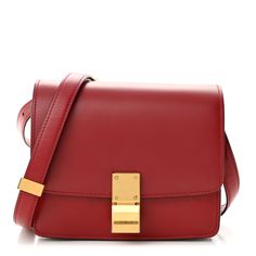 This is an authentic CELINE Box Calfskin Small Classic Box Flap Bag in Red. This chic shoulder bag is crafted of luxuriously smooth deep red box calfskin leather. The bag features a waist-length shoulder strap and a facing flap with a gold switch-lock. The flap opens to a partitioned leather interior with a zipper pocket. Luxury Red Box Bag For Office, Luxury Red Office Box Bag, Classic Red Formal Box Bag, Classic Red Square Box Bag, Classic Red Box Bag For Formal Occasions, Luxury Red Box Bag With Gold-tone Hardware, Formal Red Box Bag With Gold-tone Hardware, Red Luxury Leather Box Bag, Luxury Red Leather Box Bag