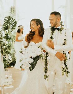 a bride and groom walking down the aisle