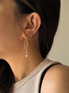 - BOWE II -  Embrace modern elegance with a twist in our new bow earrings! 🌟 The bow + dangle mini pearl drop combination is so unique - a nice blend of chic, cute, and minimalistic style. You can also choose to just have the bow on its own! Handcrafted with love and high-quality 14k gold-filled accents, these dainty earrings are made for durability and keeping sensitive skin in mind!✨ ♥ 3 style options♥  - Bow with regular back (no pearl) - Bow with the pearl dangle back - Bow with both backs (so you can wear them two-way!) //Materials// *  14k Gold Filled Bow & Gold Vermeil Post (Gold on silver) *  Freshwater natural pearls //Dimension// * Bow length: 3.3cm * Bow width: 2.8cm * Pearl drop: 4.5cm * Pearl diameter: ~3mm **Feel free to ask me anything if you have doubts //Freshwater Pearls Elegant Rose Gold Earrings With Bow, Elegant Rose Gold Bow Earrings, Elegant Gold Jewelry With Butterfly Knot, Elegant Butterfly Knot Earrings For Wedding, Elegant Wedding Earrings With Butterfly Knot, Yellow Gold Bow Earrings For Wedding, Elegant Butterfly Knot Earrings For Party, Elegant Party Earrings With Butterfly Knot, Elegant Butterfly Knot Jewelry For Party