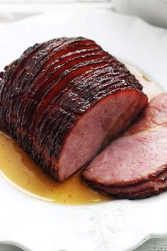 sliced ham sitting on top of a white plate