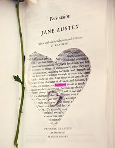 an open book with a rose on it