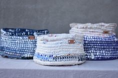 several baskets sitting on top of a table next to each other with different patterns and colors