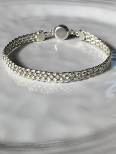 "This attractive bracelet is handwoven with sterling silver wire and finished with sterling silver end caps and secure magnetic clasp. Bracelet is approximately 1/4\" wide and will be made to fit your wrist size.   You can give me your wrist measurement and indicate the fit you prefer: snug or some wiggle room. Or you can just indicate small (6.5\"), medium (7.0\"), large (7.5\") xlarge (7.75\").   Thank you for looking in!" Classic Adjustable Braided Bracelet With Lobster Clasp, Elegant Round Sterling Silver Braided Bracelets, Handmade Classic Sterling Silver Braided Bracelets, Adjustable Braided Bangle Bracelet With Sterling Silver Clasp, Classic Handmade Sterling Silver Braided Bracelet, Elegant Sterling Silver Braided Bracelet, Elegant Braided Sterling Silver Jewelry, Classic Handmade Silver Braided Bracelets, Adjustable Silver Braided Bracelet With Sterling Clasp