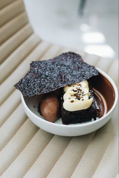 a white bowl filled with brownies and bananas