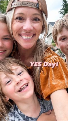 a woman and two boys are smiling for the camera with their arms around each other