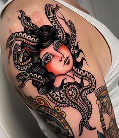 a woman's shoulder with an intricate tattoo design on her left arm and chest