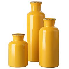 three yellow vases sitting next to each other