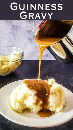 a white plate topped with mashed potatoes covered in gravy