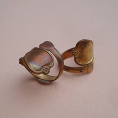 PLEASE NOTE: Rings may have an aged patina to them. Size: Hearts on end are 13mm and 6mm. Quantity: 2 Material: Brass *These metal settings are Lead & Nickel FREE* PLEASE NOTE: Please read my store policies before agreeing to purchase LINK TO POLICIES --> http://www.etsy.com/shop_policy.php?user_id=5963982 Vintage Open Heart Ring For Promise, Vintage Open Heart Promise Ring, Vintage Adjustable Metal Rings, Vintage Hand Forged Bronze Ring, Vintage Hand-forged Bronze Rings, Vintage Copper Ring Jewelry, Vintage Bronze Open Ring, Adjustable Vintage Heart Ring, Vintage Hand Forged Promise Rings