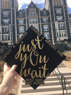 someone is holding up a graduation cap that says just go your heart next to some stairs