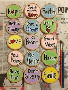 decorated cookies with words on them sitting in front of a newspaper