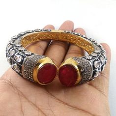 This Listing is for 1 Piece Beautiful Red Garnet & CZ Hydro Gemstone 24k Gold Plated Cuff Bangle Bracelet Jewelry Gemstone: Red Garnet & CZ Metal : Brass Style : Cuff Bracelet Size : Cuff Adjustable Size Plating : 24k Gold Plated & Black Oxidize Color : Yellow,White, Black Note : We Ship Parcel Via India Post Economy Shipping It's Take 20 To 25 Days To Arrive. Check my other items frequently. I will be adding to the inventory regularly. Be sure to visit my shop to check for any coupo Red Ruby Bangle As Gift, Red Jeweled Bracelets As Gift, Red Jeweled Bracelets For Gift, Red Bangle Jewelry With Jewels, Handmade Ruby Bangle Bracelet, Jeweled Bangle Cuff Bracelet As Gift, Jeweled Cuff Bangle Bracelet For Gift, Red Ruby Bracelet For Festive Occasions, Festive Red Ruby Bracelet