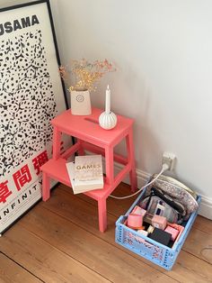 a pink table with some items on it next to a white and black sign that says usama