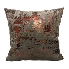 a silver and red pillow with an abstract design on the front, sitting against a white background