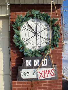 a christmas clock hanging on the side of a building