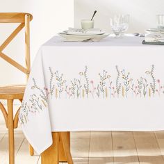 a white table cloth with flowers on it