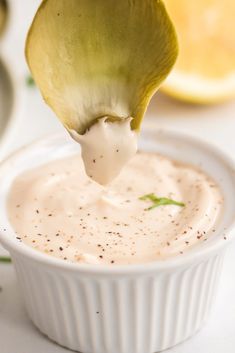 a spoon full of dip being lifted from a bowl