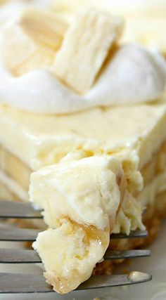 a piece of pie sitting on top of a white plate with a fork next to it