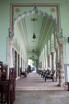 the inside of an old building with many chairs and tables lined up on either side