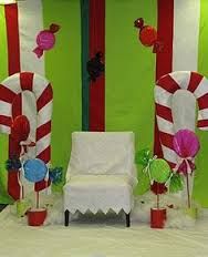 candy canes and decorations are on display in front of a green wall