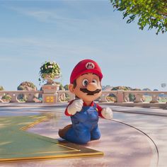 mario is sitting on the ground next to a star