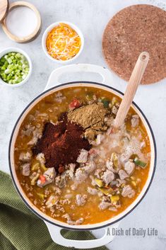 the soup is prepared and ready to be cooked in the pot with ingredients around it