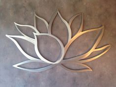 a metal wall sculpture with a flower on it