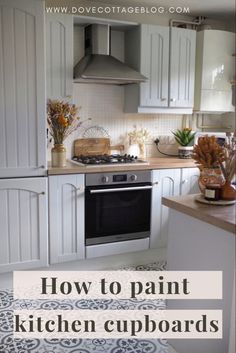 a kitchen with white cabinets and black and white flooring that says how to paint kitchen cupboards