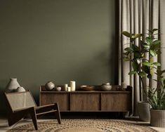 a living room with green walls and a rug on the floor next to a chair