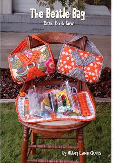 an orange and white bag sitting on top of a wooden chair