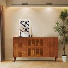 a large wooden cabinet sitting in the middle of a living room next to a potted plant