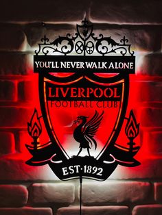 liverpool football club illuminated sign on brick wall