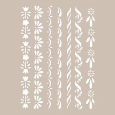 the stencil set is designed to look like flowers and swirls in white on a light gray background