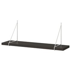 a black shelf with two white poles on it and one is hanging from the ceiling