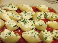 some ravioli with cheese and sauce in a glass dish on top of a table