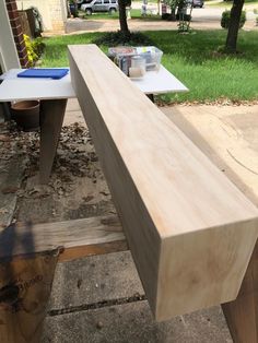 a wooden bench sitting on top of a sidewalk