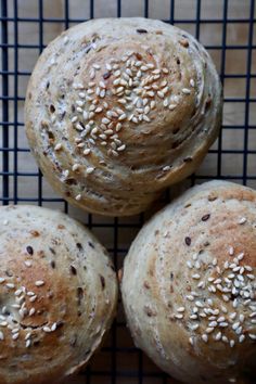 three loaves of bread on a cooling rack