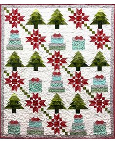 a quilted christmas tree with red, green and white stars on the top is shown