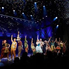 a group of people on stage with confetti flying in the air above them