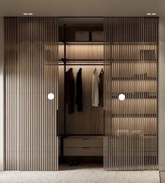 an open closet with clothes hanging in it