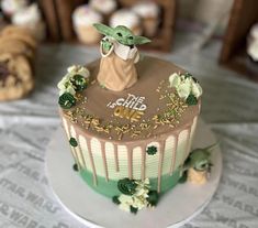 a star wars themed cake with the baby yoda on top