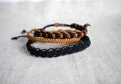 This listing is for a set of three cord bracelets, handmade by macramé, in black, plum and mustard. Perfect jewel for him or for her, comfortable, resistant, to add a boho, surf, modern touch to your outfit! You will recive this bracelet set in a lovely gift packaging ♥ - - - - - - - - - - - - - - - - - - - ▼ Width: approx 4 mm (0.2 inches), the largest is 8 mm (0.3 inches) ▼ Each bracelet has a sliding knot to adjust the length to the size you need. ▼ Made of high quality waxed thread, water an Handmade Waxed Cord Friendship Bracelets, Affordable Black Resizable Friendship Bracelets, Neutral Colored Friendship Bracelets, Wax Bracelets, Techniques Textiles, Boho Surf, Reef Knot, Bracelet Pack, Surfer Bracelets