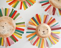 paper plate lion and lion faces are displayed on the wall with colorful strips of construction paper