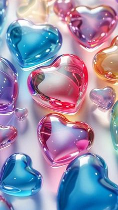 many different colored hearts on a white surface