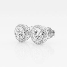 A popular style in Europe, these bezel set halo diamond stud earrings look solid, without being heavy on the ears. Each large round lab grown diamond is set in a bezel, which is then surrounded by smaller round diamonds. Classic Round Diamond Earrings With Halo, Classic Round Cut Diamond Earrings With Halo Setting, Classic Round Halo Diamond Earrings, Classic Diamond Earrings With Halo Setting For Anniversary, Classic White Gold Diamond Earrings With Halo Setting, Classic Halo Diamond Earrings For Anniversary, Round Cut Halo Diamond Earrings For Anniversary, Diamond Stud Earrings, Diamond Stud