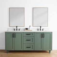 two mirrors are above the double sinks in this bathroom